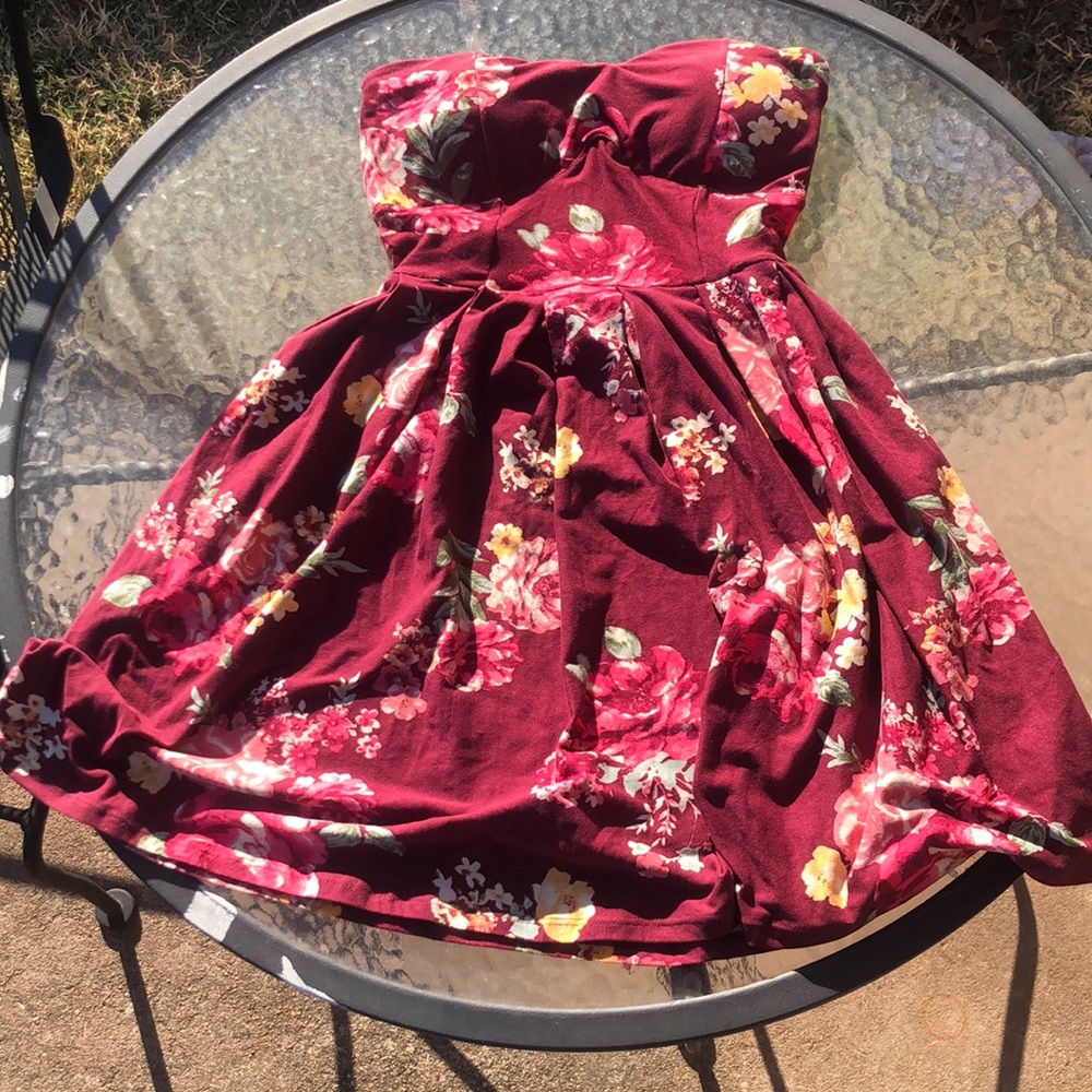 Short maroon strapless dress has flowers on it